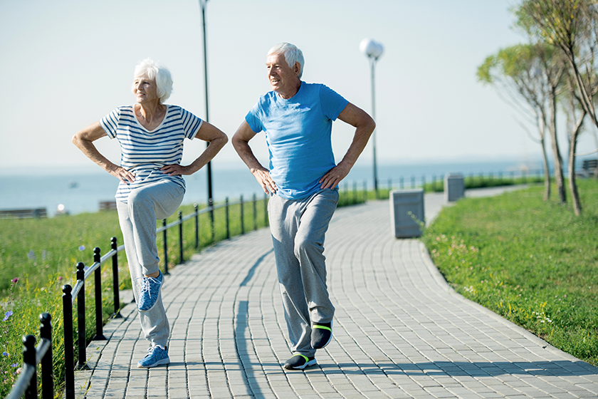 Full length portrait of active senior couple doing fitness exercise